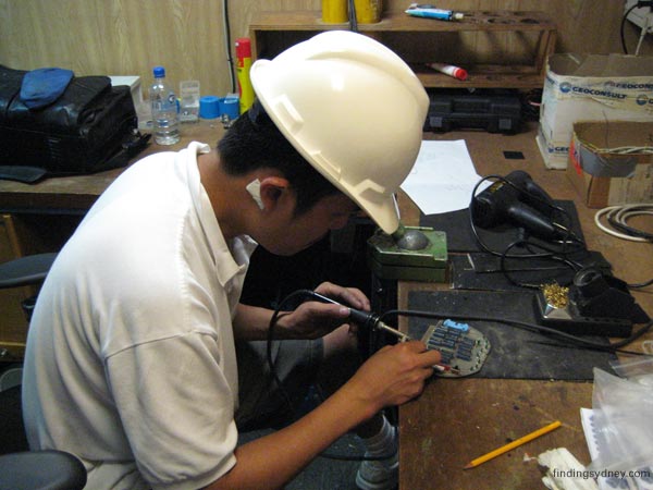 Carter Le working on a printed circuit board for the sonar equipment.